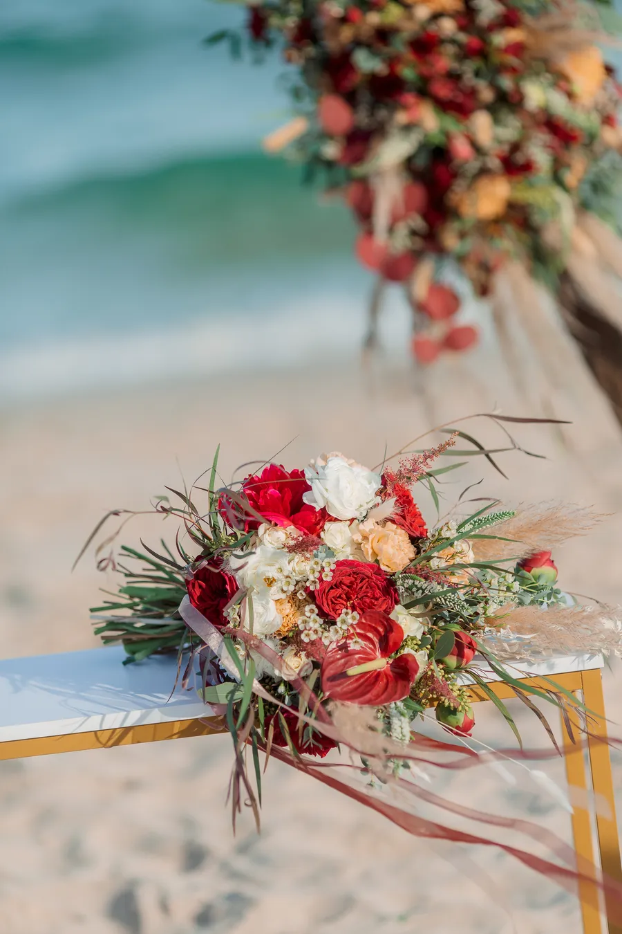 Reception table and ceremony chairs arranged on the sand — Roman and Victoria wedding