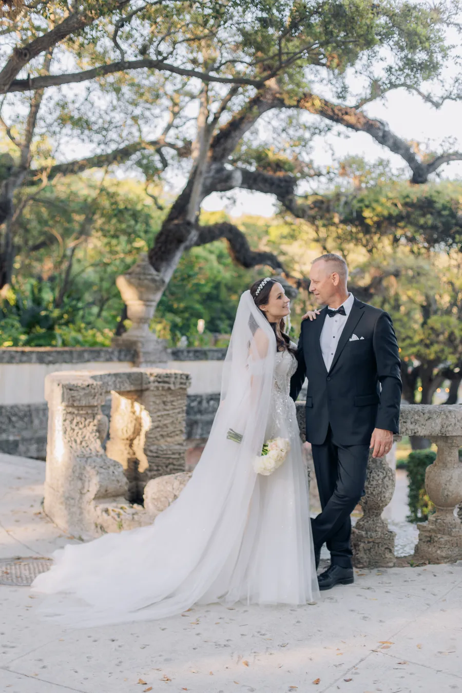 Bride and groom beside ornate stone architecture — Steven and Iryna wedding