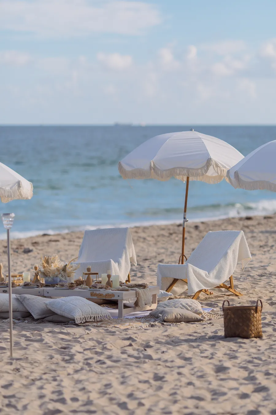 Beach wedding ceremony setup overlooking turquoise water — Roman and Victoria wedding