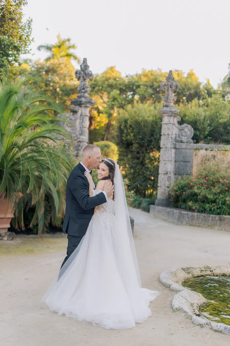 Bride and groom beside ornate stone architecture — Steven and Iryna wedding