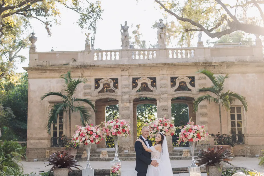 Bride walking through the floral ceremony aisle — Steven and Iryna wedding