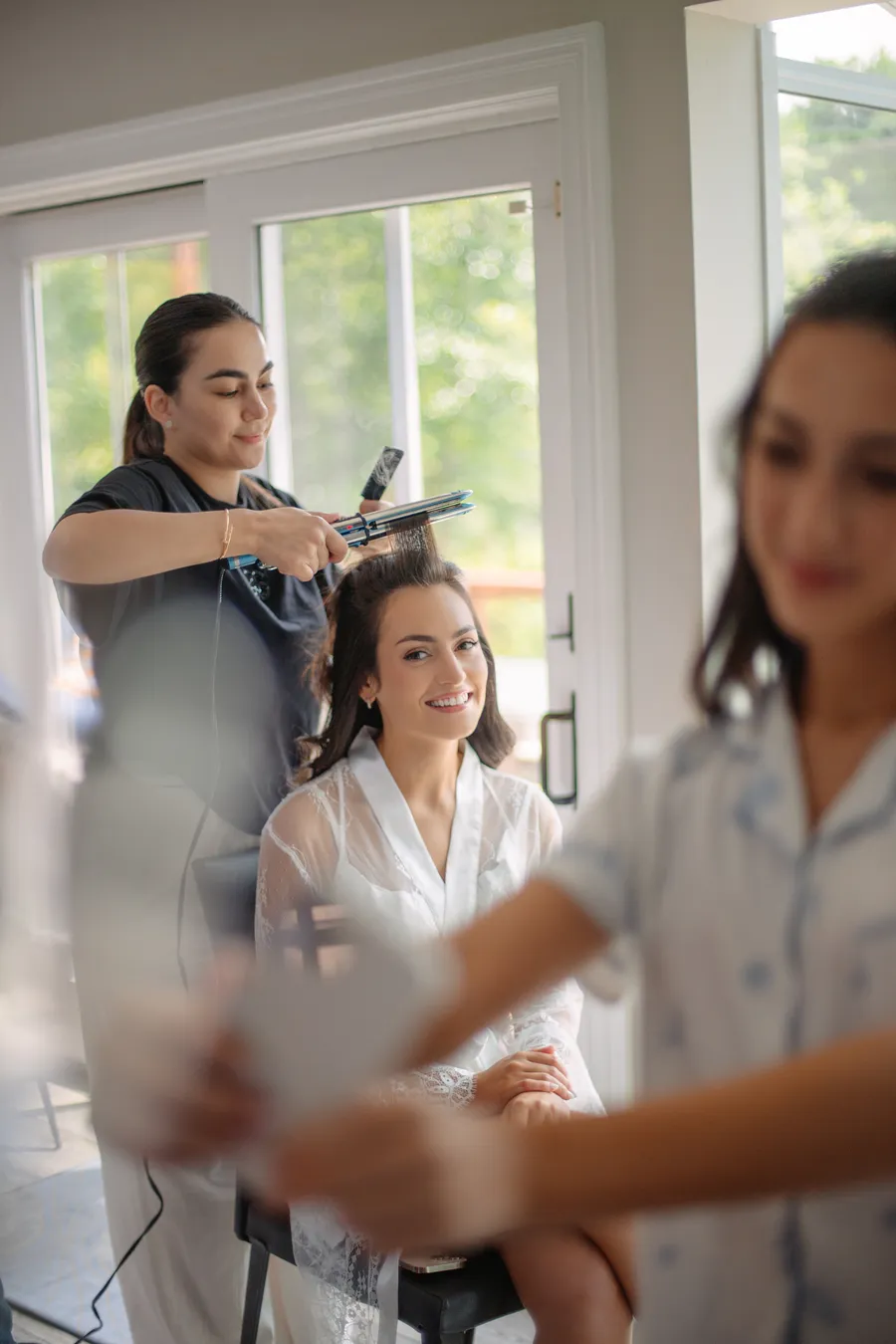 Bride adjusting her jewelry in a bright room — David and Katia wedding