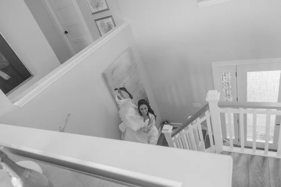 Bride adjusting her jewelry in a bright room — David and Katia wedding