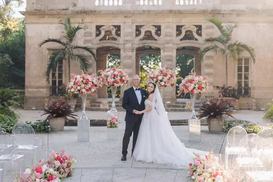 Flower-lined wedding aisle in a historic garden courtyard — Steven and Iryna wedding