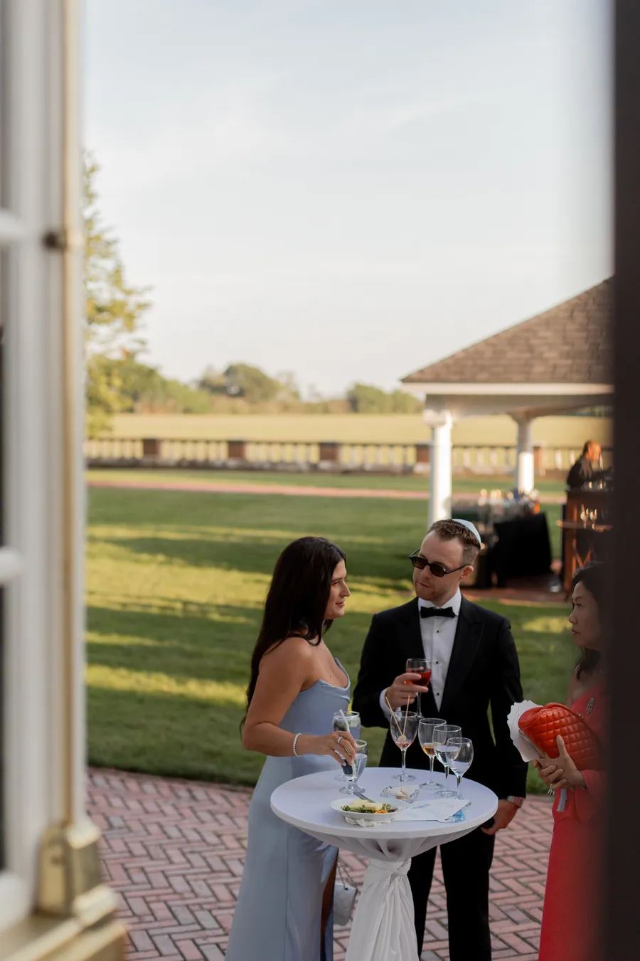 Cocktail-hour guests on the garden terrace — David and Katia wedding