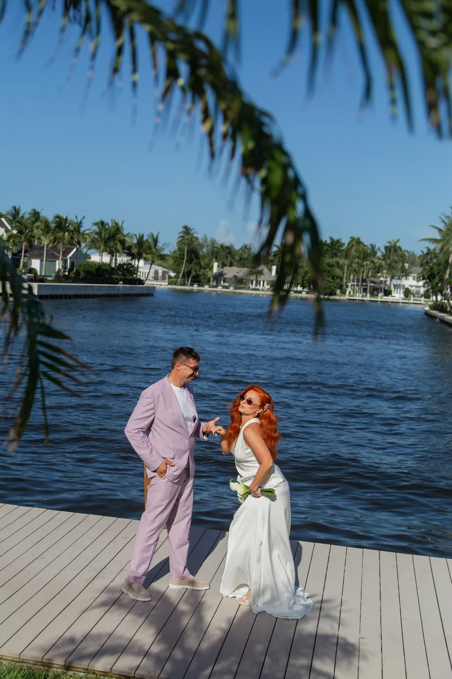 Newlyweds holding hands beside the water — Alexander and Olga wedding