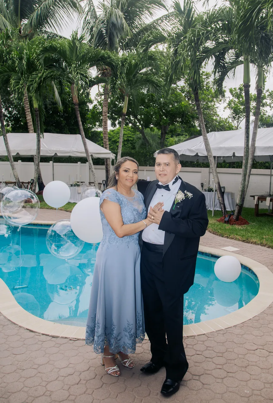 Wedding guests laughing together near the pool — Chris and Laura wedding