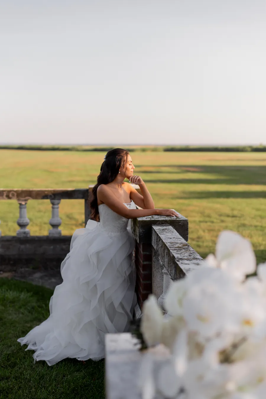 Newlyweds sharing a portrait beside the brick estate — David and Katia wedding