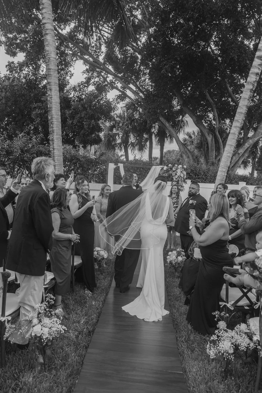 Black-and-white candid from the outdoor ceremony — Chris and Laura wedding