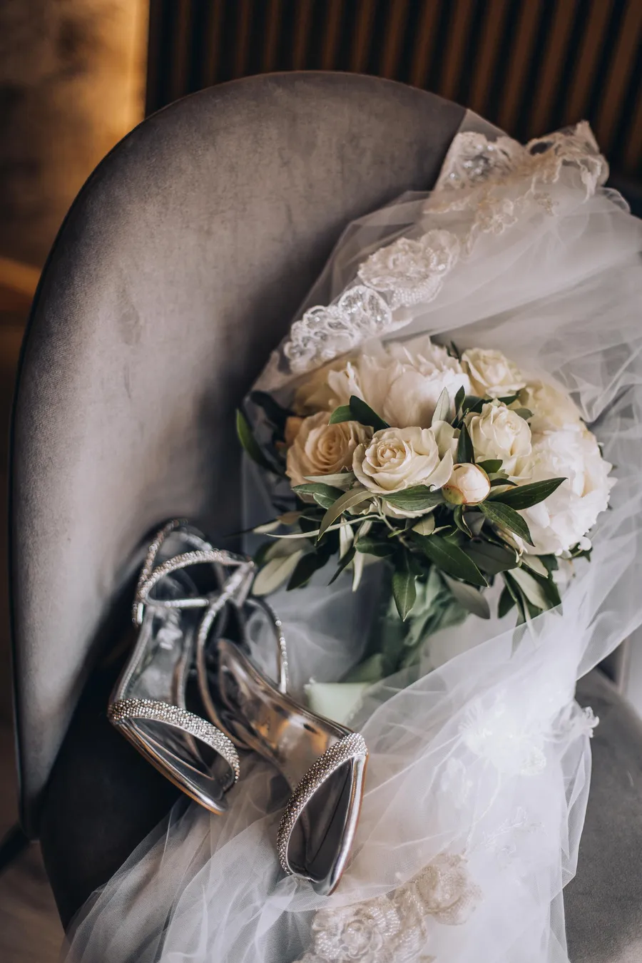 White bridal bouquet resting on a dark chair