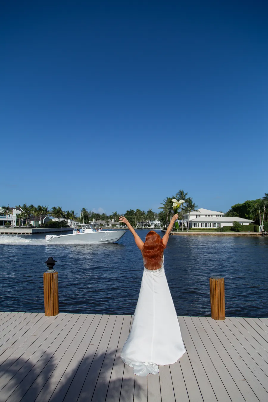 Bride walking along a sunny waterfront dock — Alexander and Olga wedding