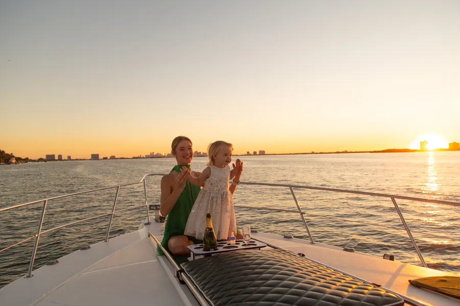 Family portrait on a waterfront pier at sunset