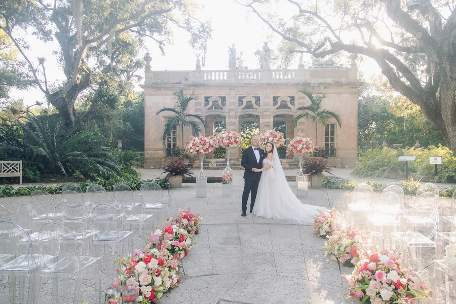 Flower-lined wedding aisle in a historic garden courtyard — Steven and Iryna wedding