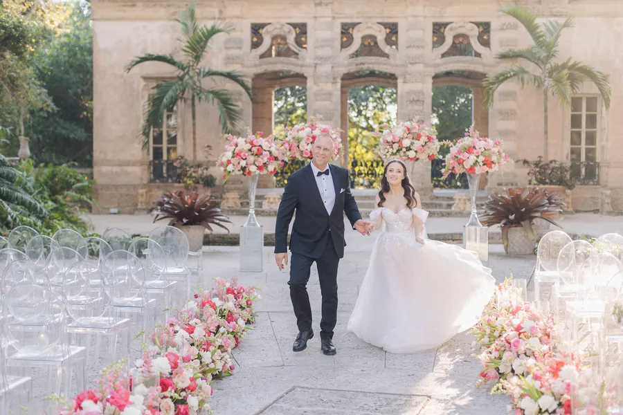 Elegant outdoor ceremony setting with white chairs and pink flowers — Steven and Iryna wedding