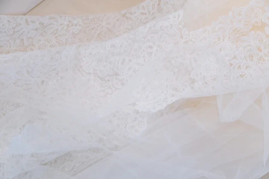 Delicate white wedding dress fabric photographed in soft light — David and Katia wedding
