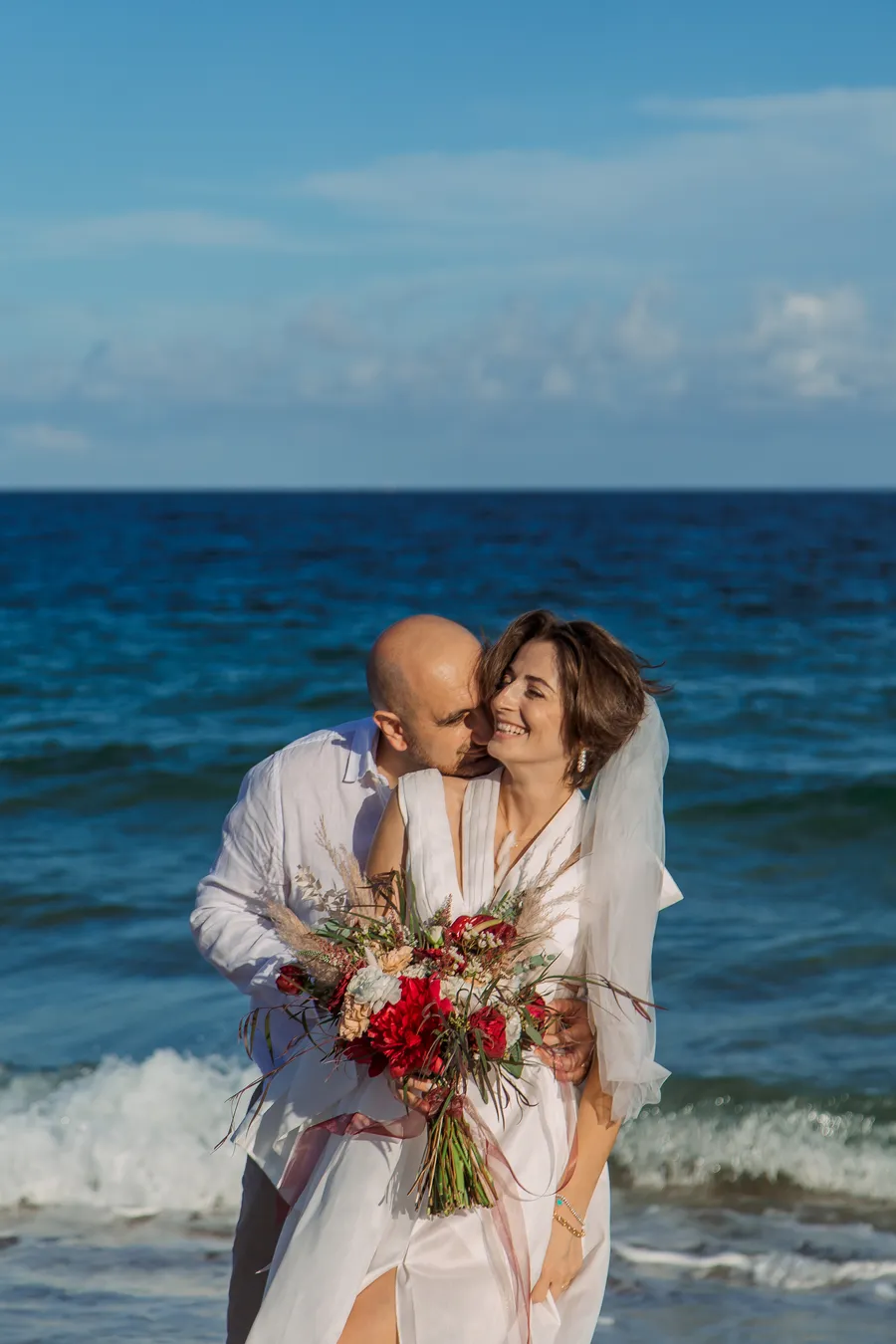 Bride walking along the shoreline before the ceremony — Roman and Victoria wedding
