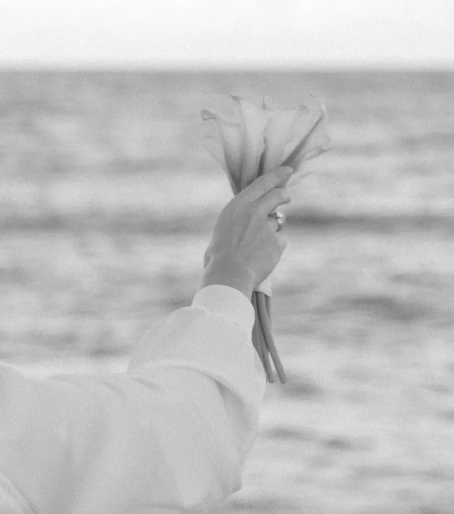 Black-and-white bridal portrait by the ocean