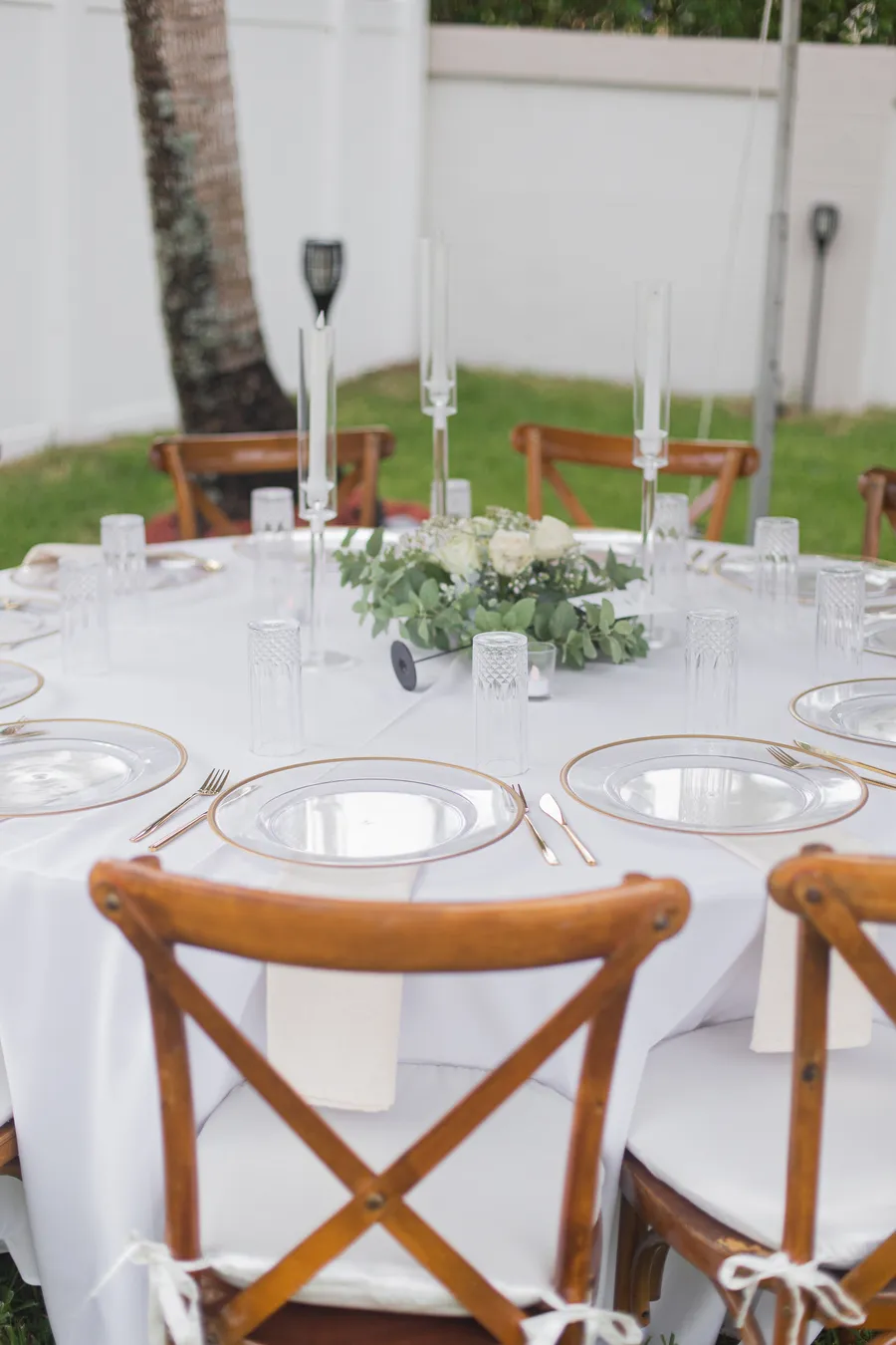 Long reception table styled with candles and greenery — Chris and Laura wedding