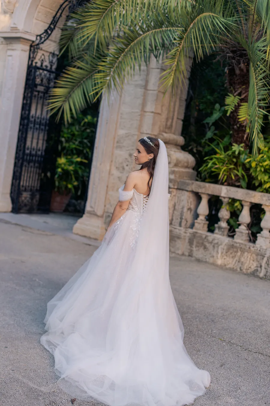 Newlyweds walking through tropical garden grounds — Steven and Iryna wedding