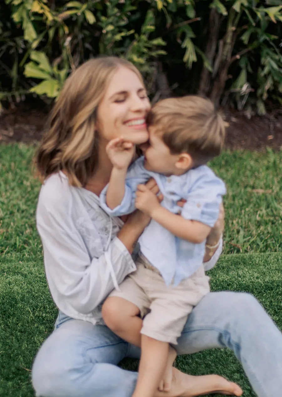Mother holding her toddler during a natural outdoor family portrait
