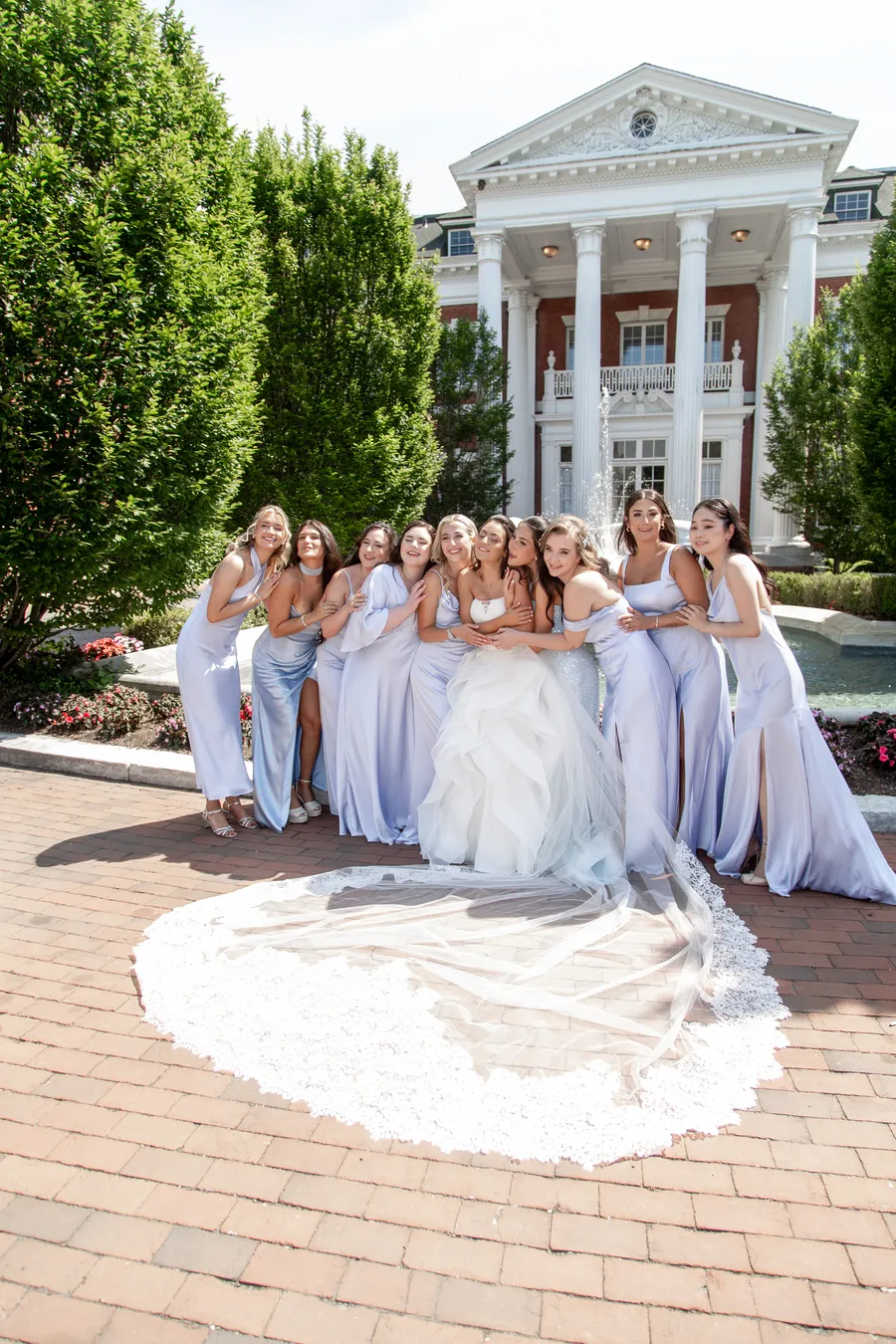 Bride posing with bridesmaids in pale blue dresses — David and Katia wedding