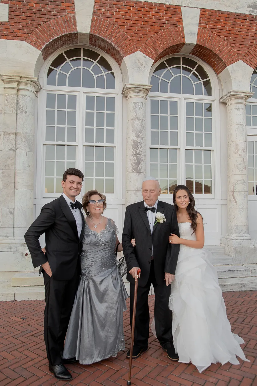 Newlyweds sharing a portrait beside the brick estate — David and Katia wedding