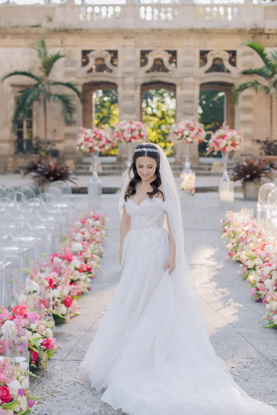 Bride and groom beneath abundant pink ceremony flowers — Steven and Iryna wedding