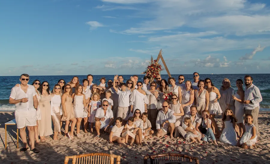 Wedding guests cheering together on the sand — Roman and Victoria wedding