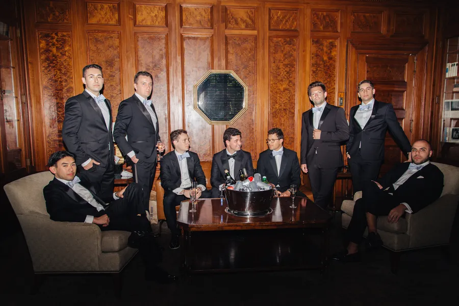 Groom and groomsmen posing in a wood-paneled library — David and Katia wedding