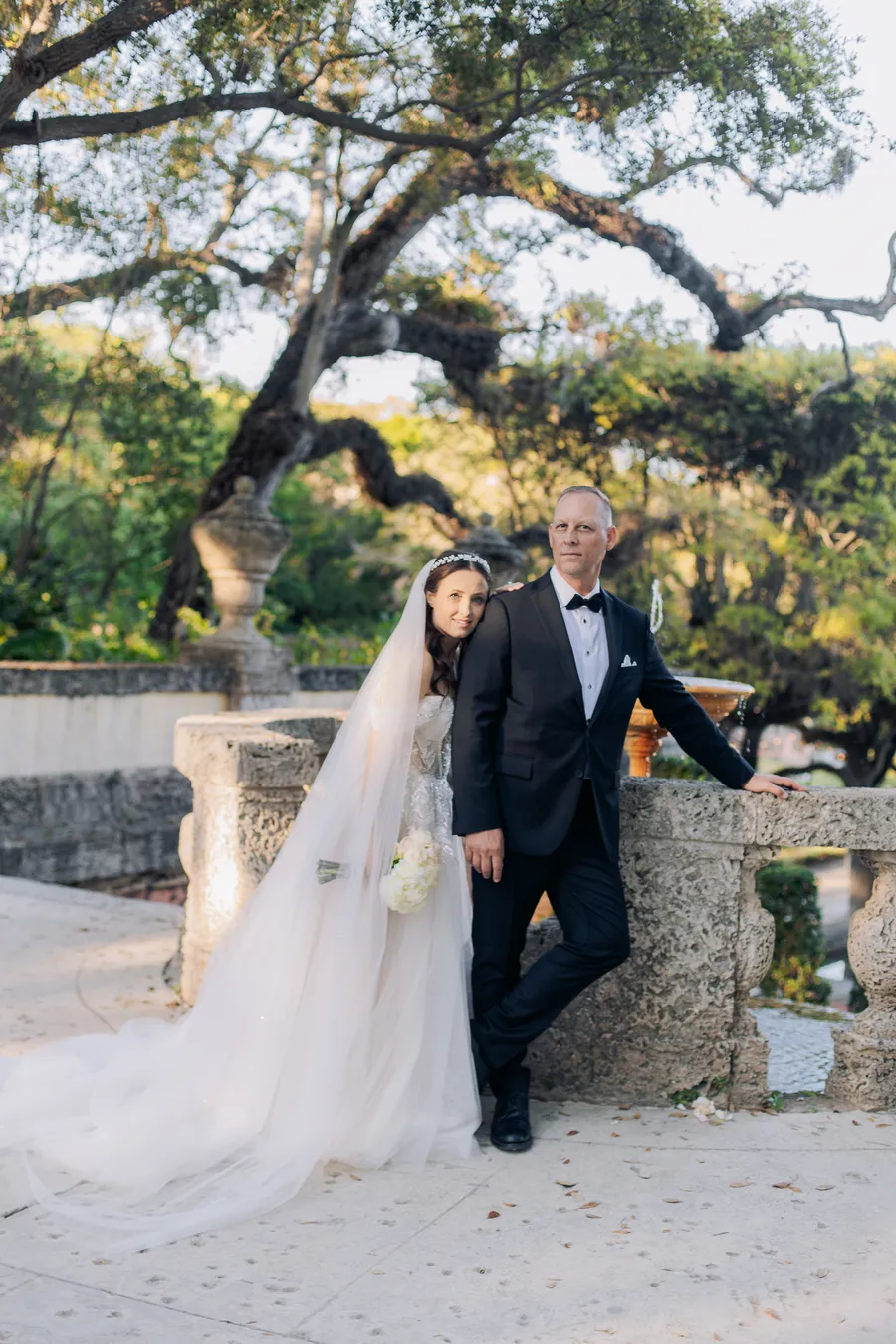 Newlyweds walking through tropical garden grounds — Steven and Iryna wedding