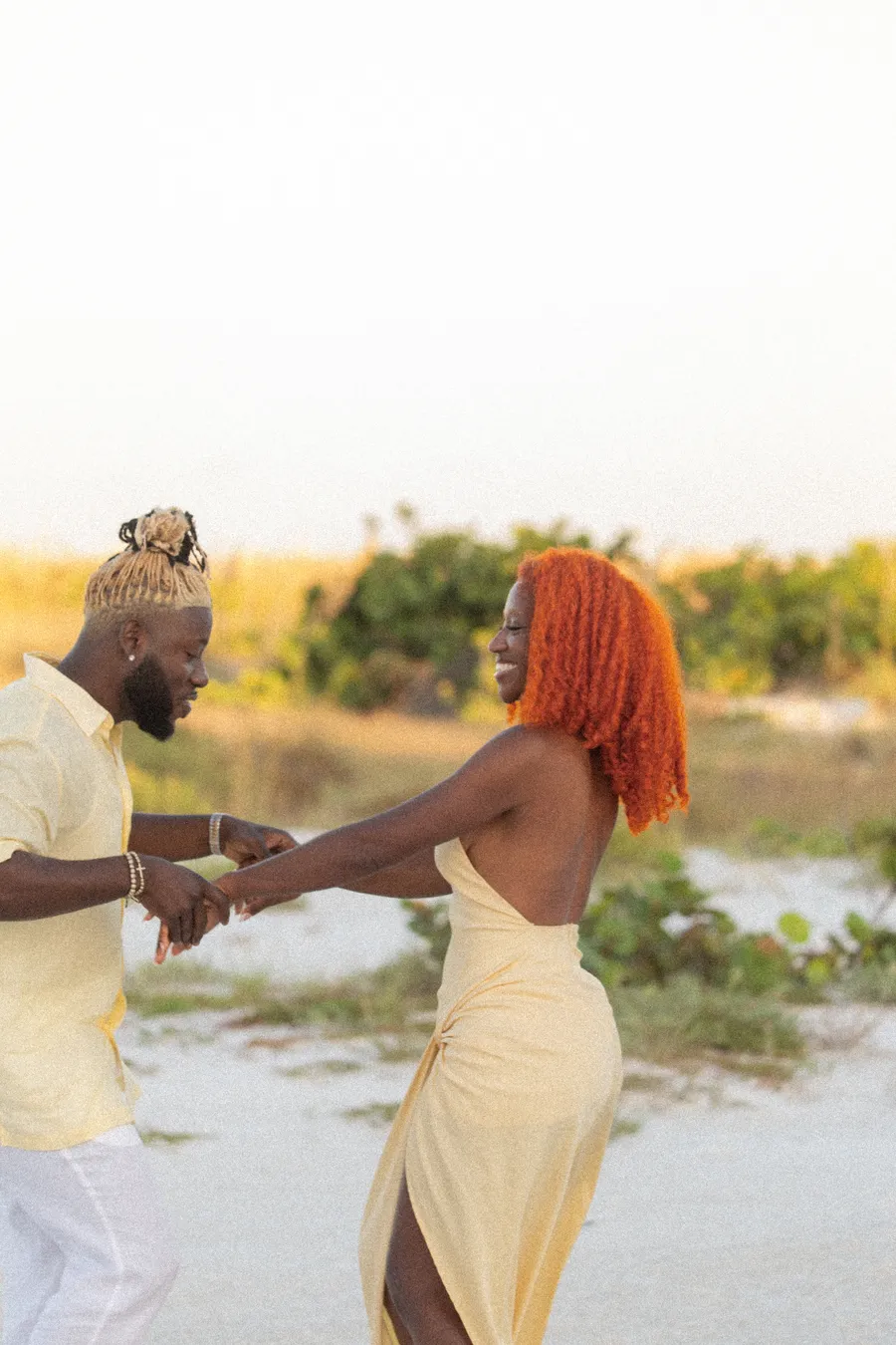 Couple laughing and dancing during a family beach session