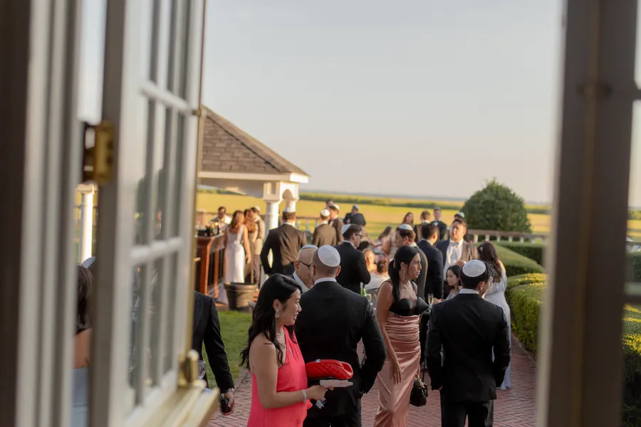 Newlyweds sharing a portrait beside the brick estate — David and Katia wedding