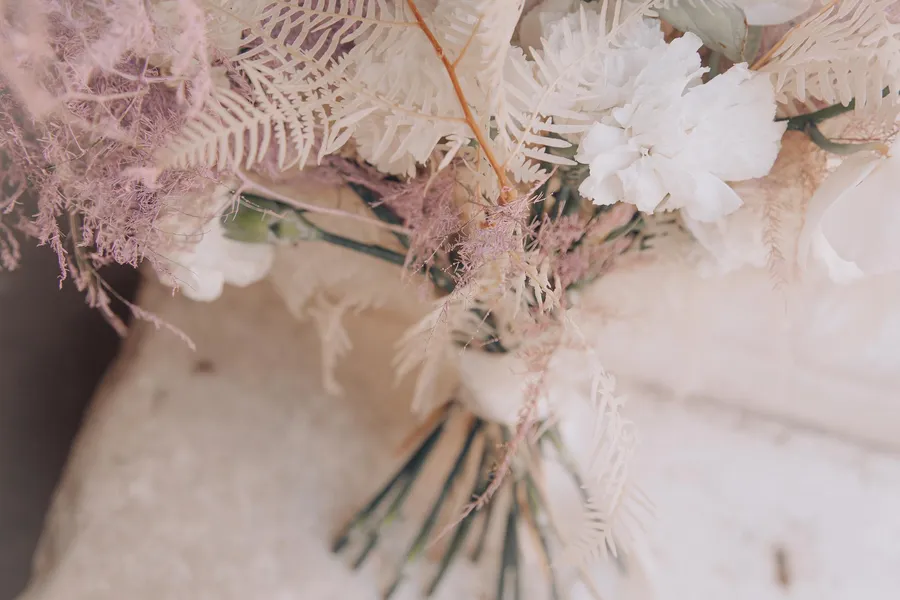 Soft neutral bridal bouquet with lace and dried flowers