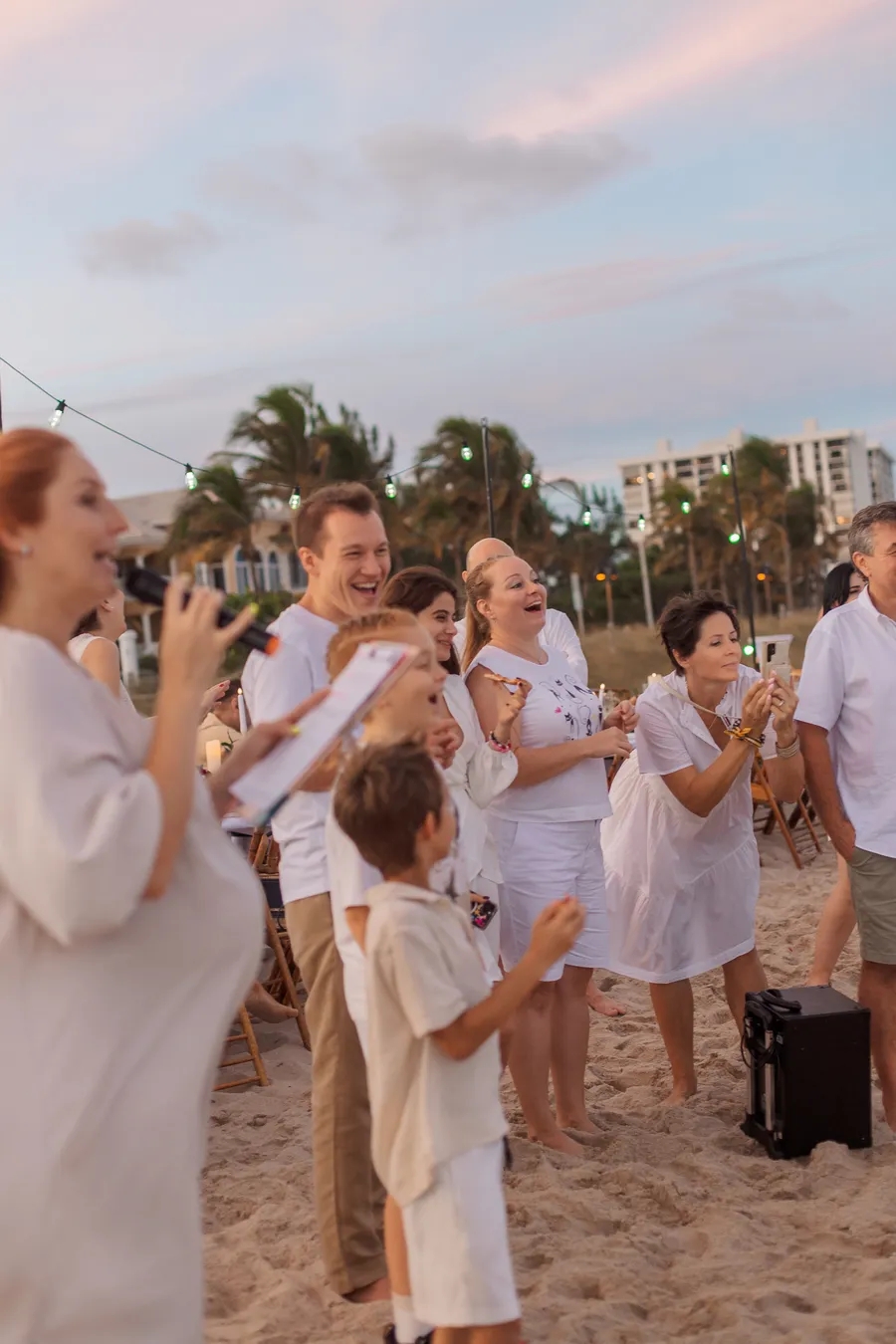 Bride holding a child during the beach reception — Roman and Victoria wedding