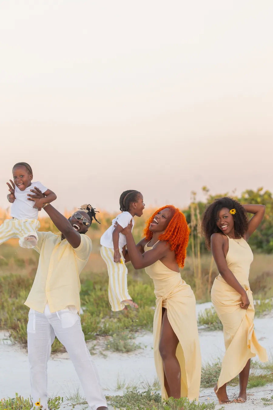 Family laughing together during a relaxed beach photo session