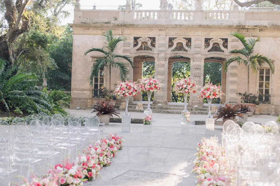 Flower-lined wedding aisle in a historic garden courtyard — Steven and Iryna wedding