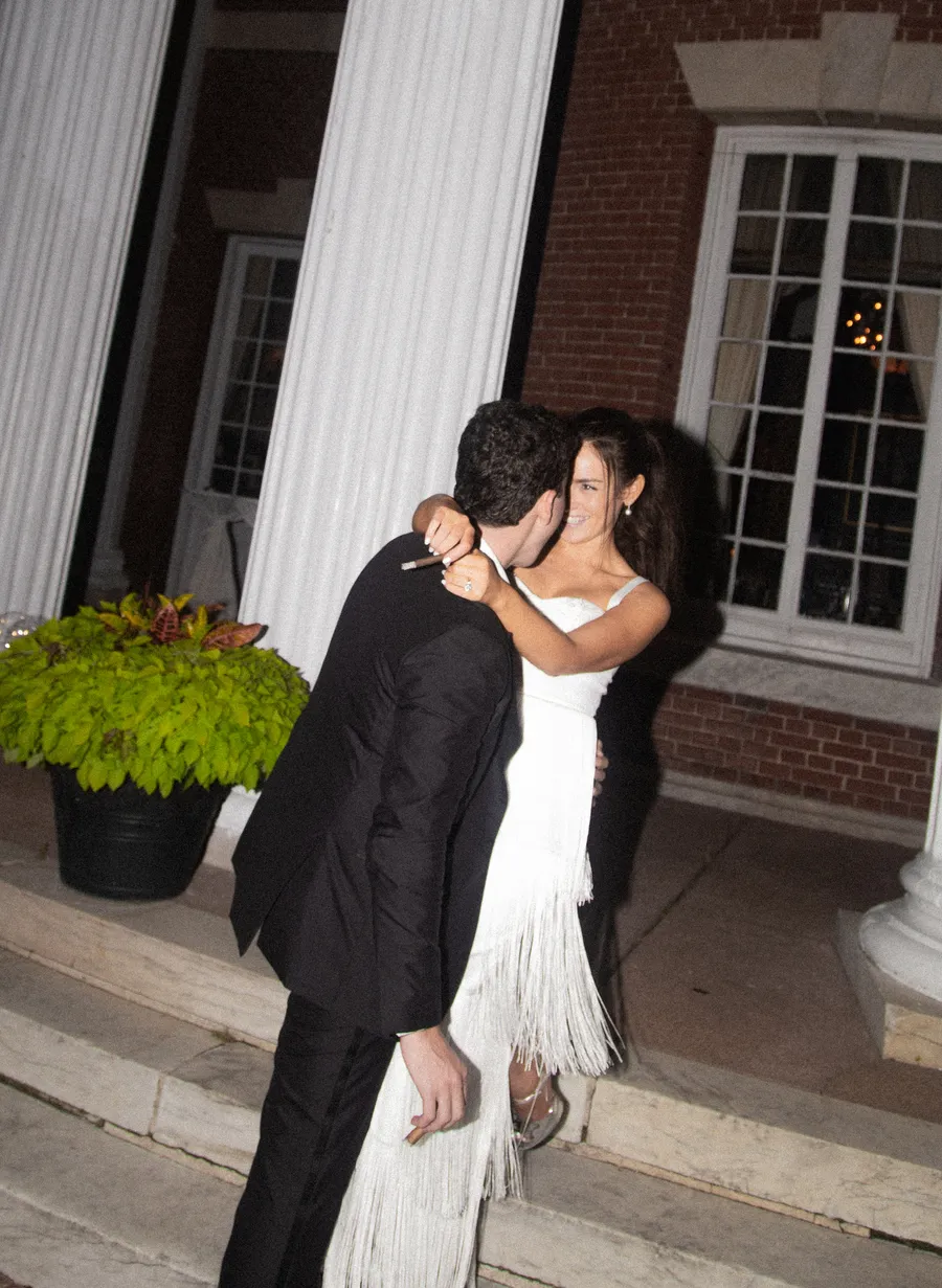 Bride and groom dancing beneath warm reception lights — David and Katia wedding