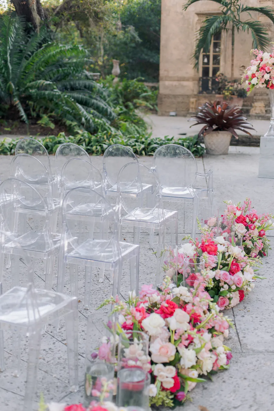 Elegant outdoor ceremony setting with white chairs and pink flowers — Steven and Iryna wedding