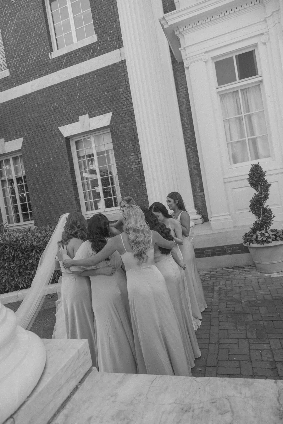 Bride posing with bridesmaids in pale blue dresses — David and Katia wedding