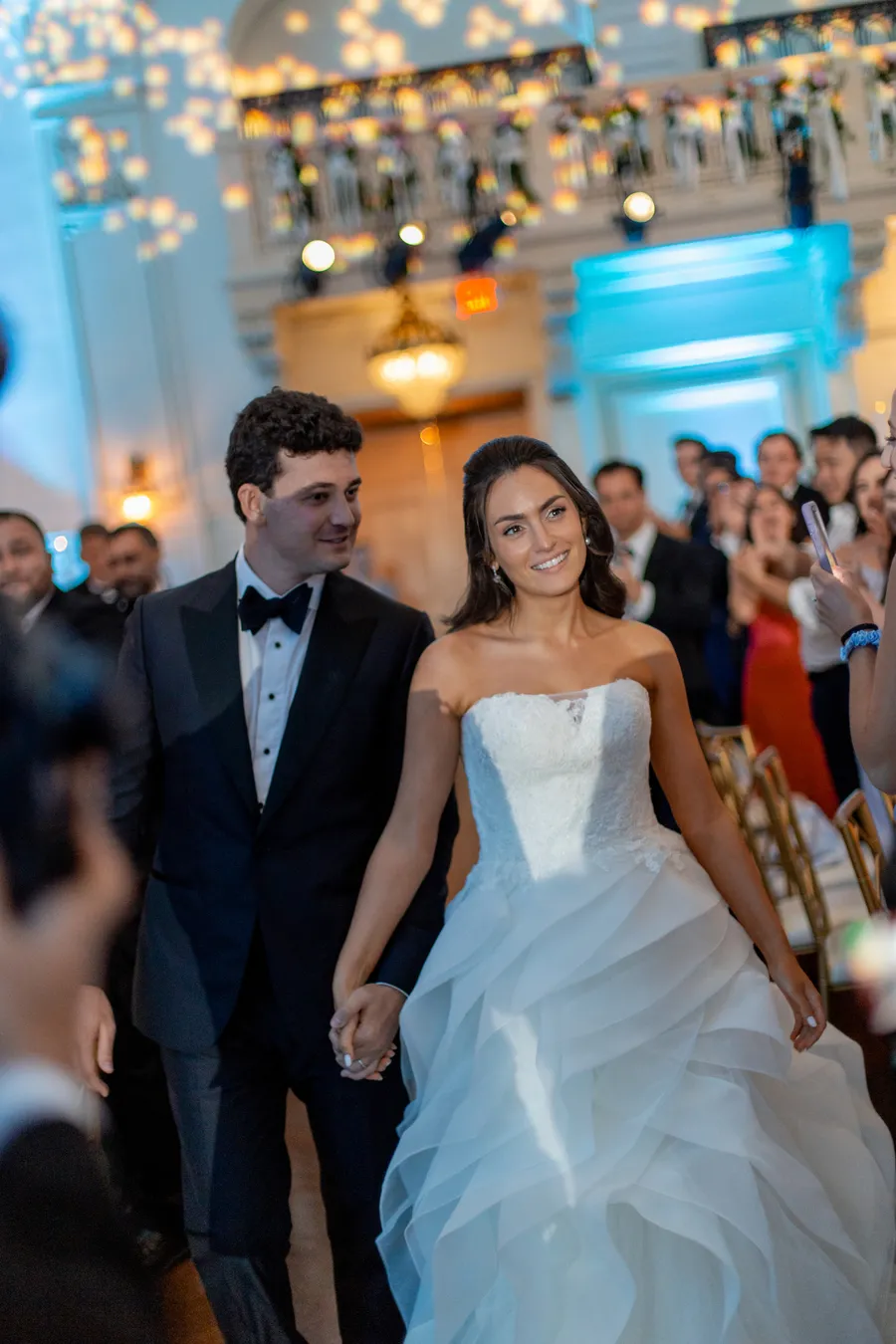 Bride and groom dancing beneath warm reception lights — David and Katia wedding