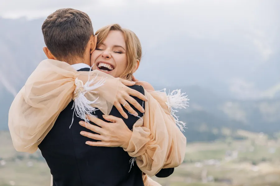 Emotional embrace between a bride and a wedding guest