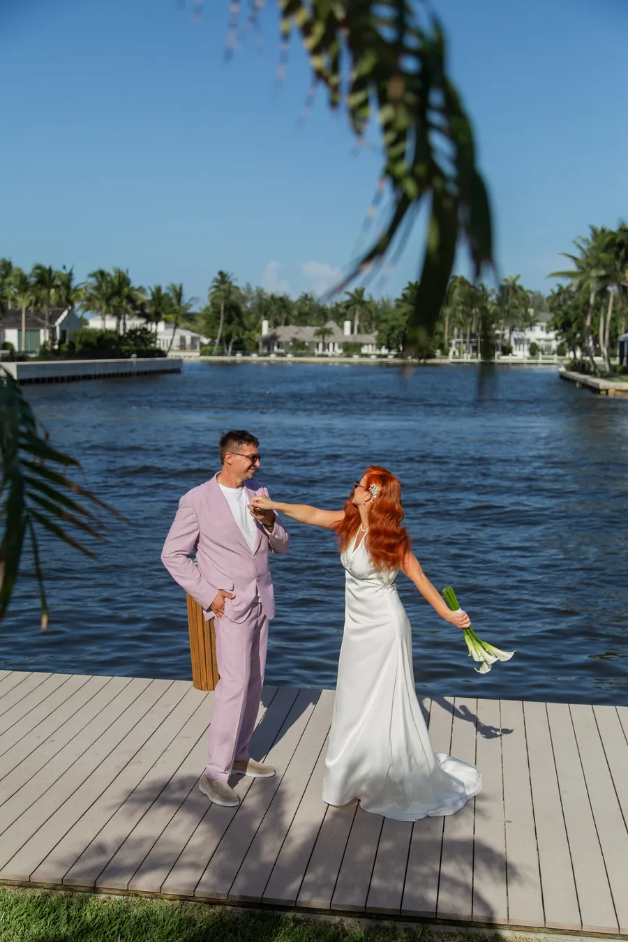 Bride walking along a sunny waterfront dock — Alexander and Olga wedding