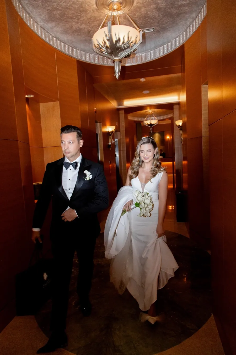 Bride and groom entering an elegant indoor wedding venue