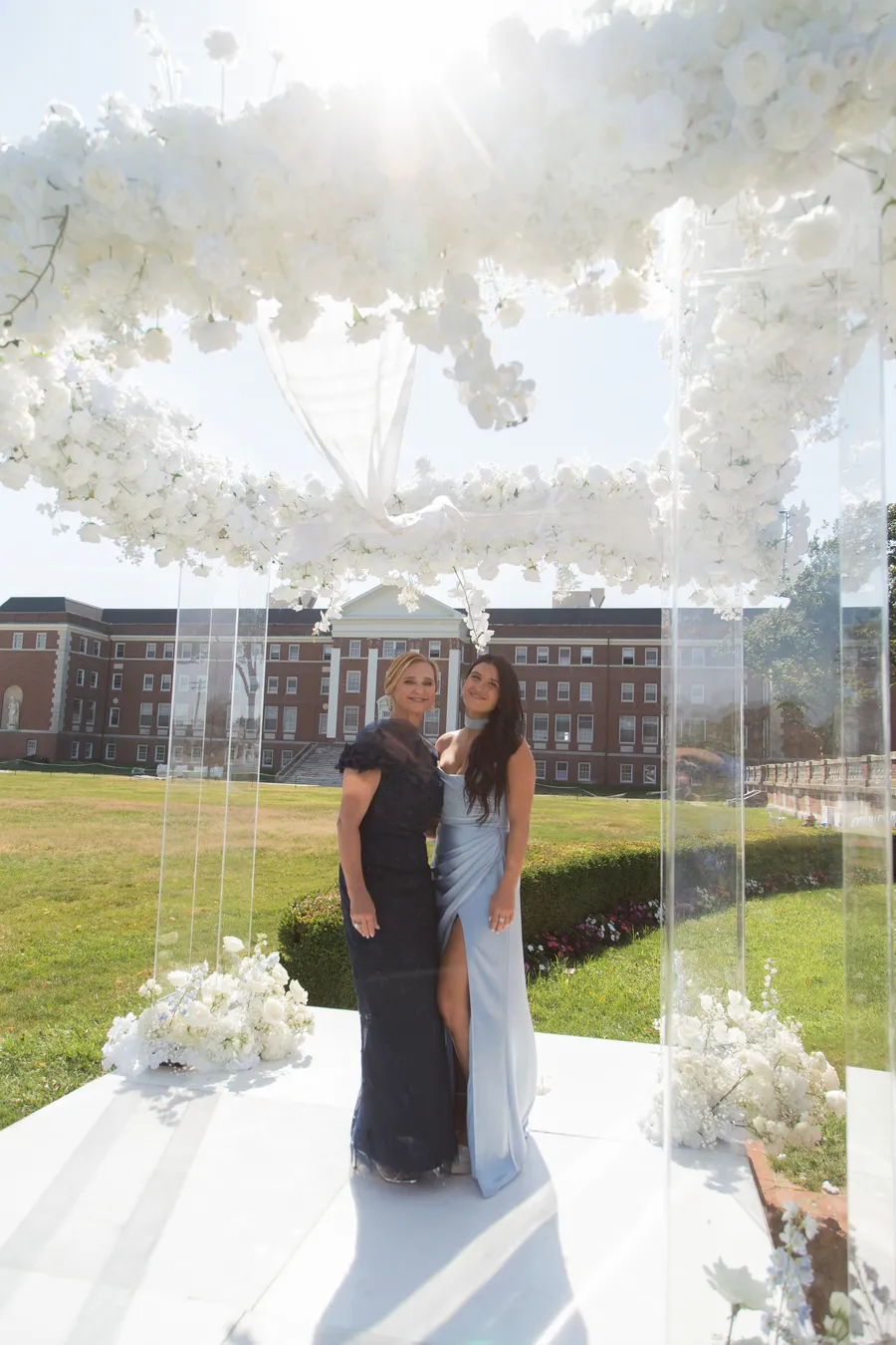Newlyweds embracing at the flower-lined ceremony aisle — David and Katia wedding