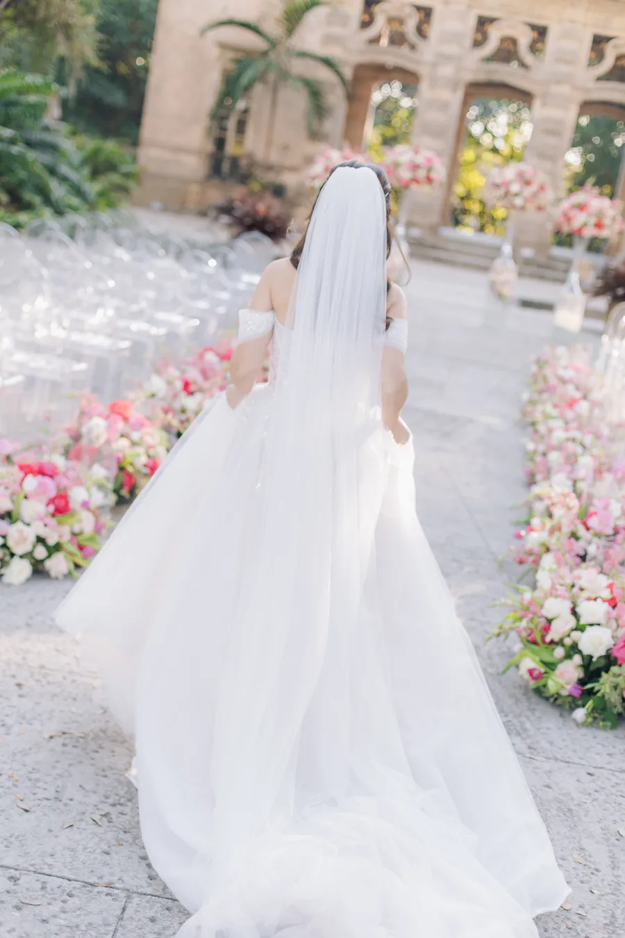 Bride walking through the floral ceremony aisle — Steven and Iryna wedding