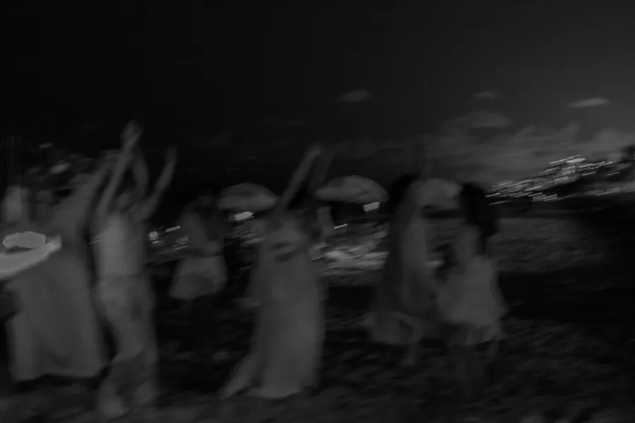 Nighttime wedding party moving along the shoreline — Roman and Victoria wedding