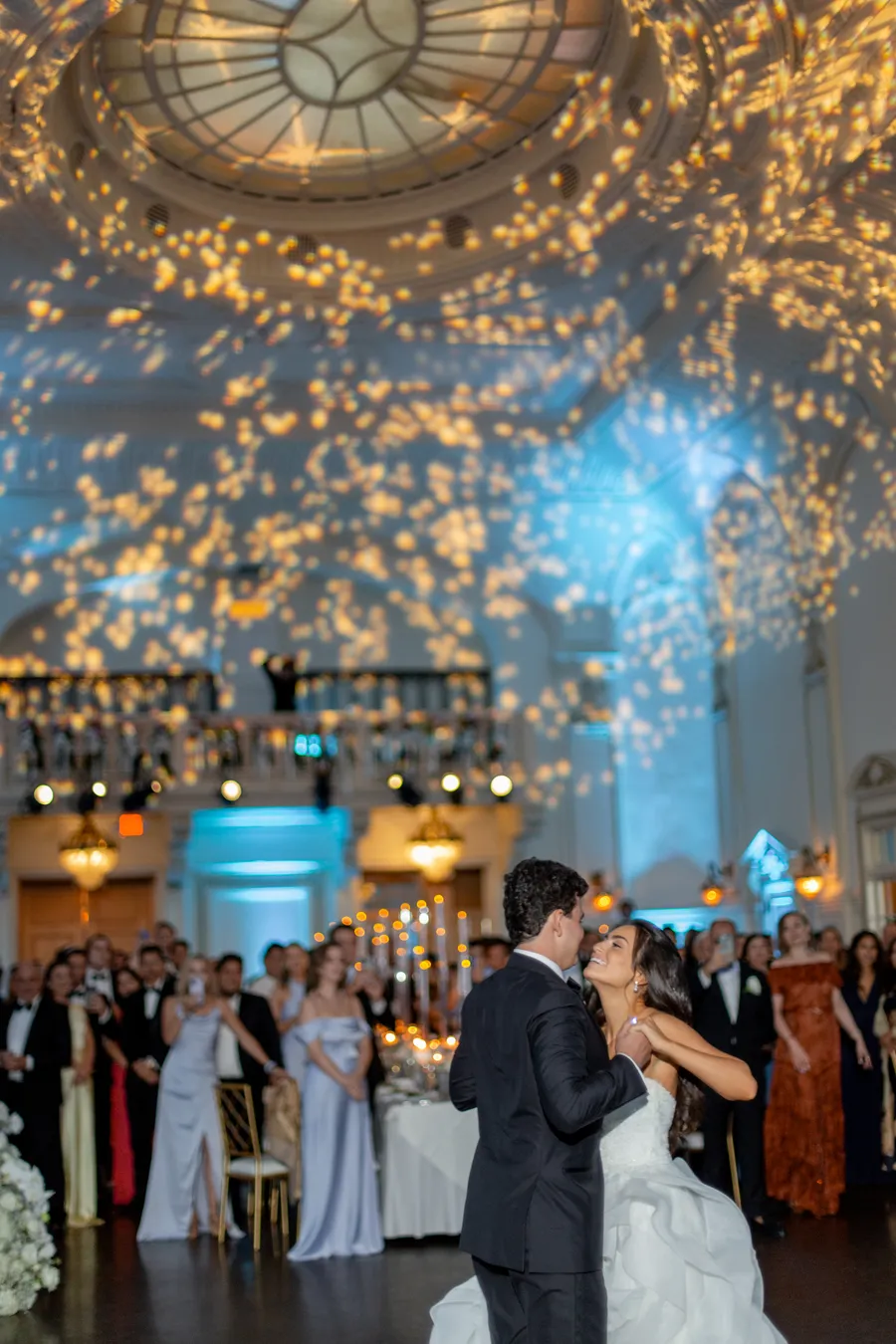 Bride and groom dancing beneath warm reception lights — David and Katia wedding