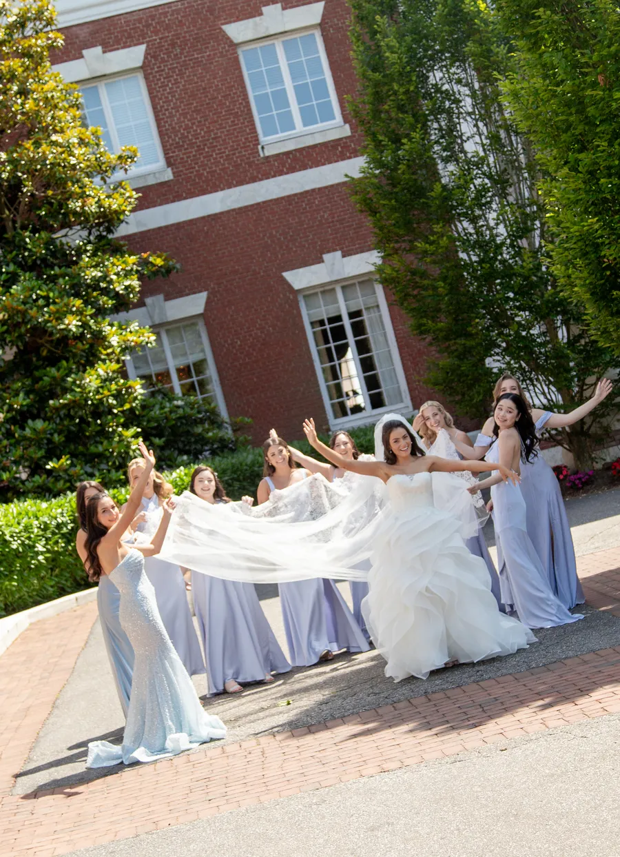 Bride posing with bridesmaids in pale blue dresses — David and Katia wedding