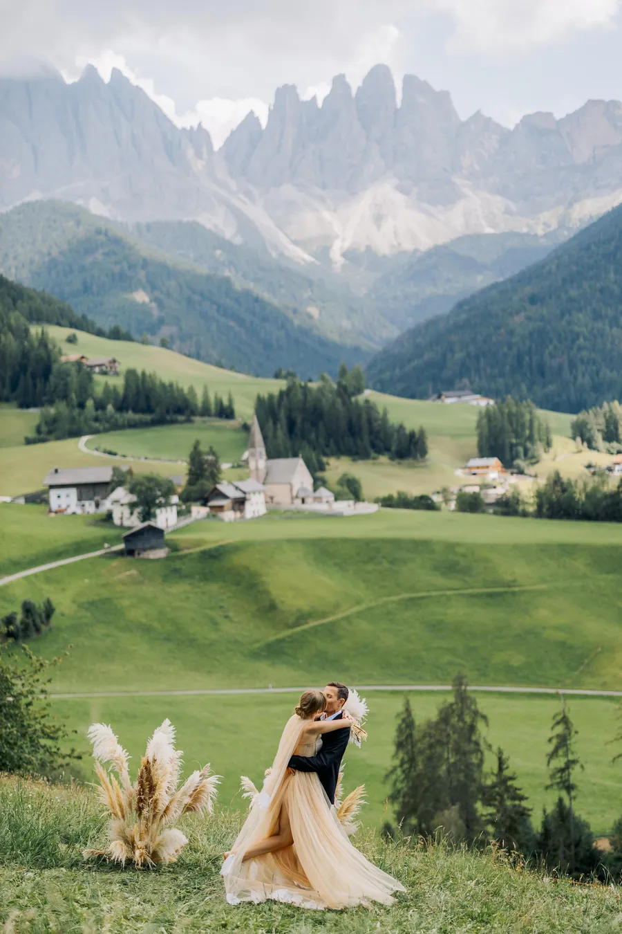 Bride standing in a dramatic mountain valley landscape