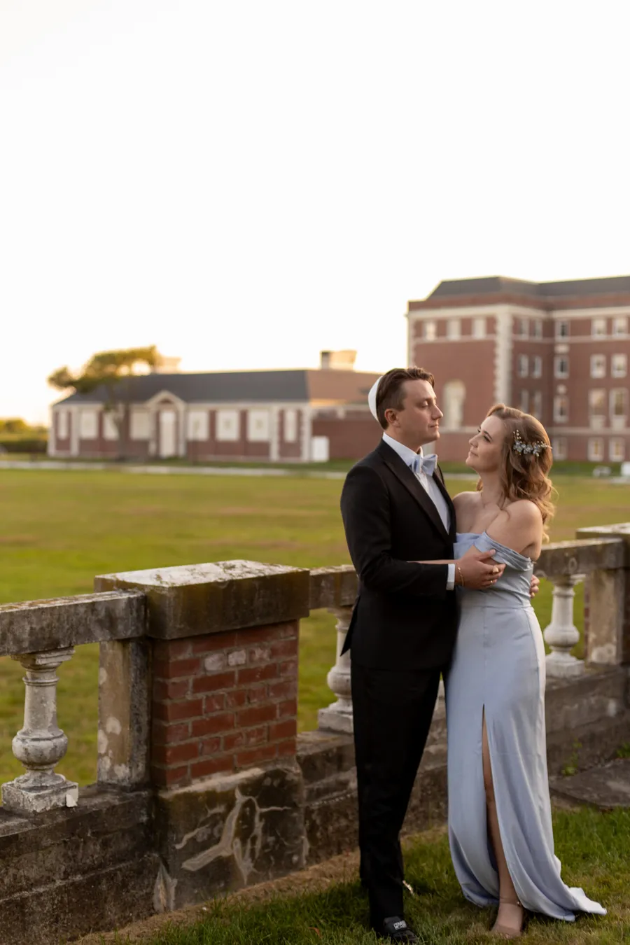 Newlyweds sharing a portrait beside the brick estate — David and Katia wedding
